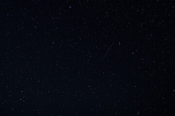 The fall of a star in a dark night sky