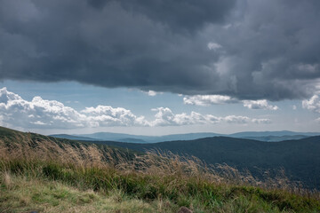 Heavy, dark clouds over the tops of the mountains , windy day, Bieszczady Mountains, Poland