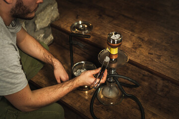 Shisha hookah with red hot coals. Sparks from breathe. Modern hookah with coconut charcoal for relax and shisha smoke. Hookah and sparks from coals.