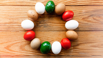 Easter eggs as the color of the Italian flag - green, white, red in nest.	Happy Easter holiday background