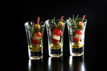 Shot glass appetizer. Tomato, olive, and fresh mozzarella salad