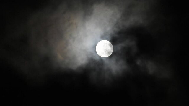 full moon and moving clouds with a few bats flying around