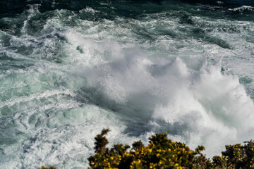 Seawater from a wave as it breaks against a rock, sea foam