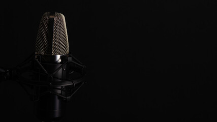 Studio microphone in studio on a black background.Advertising school vocals, readings te text, podcasts