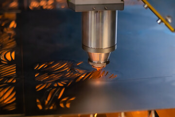 Automatic cnc laser cutting machine working with sheet metal with sparks at factory, plant. Metalworking, industrial, equipment, technology, machining, manufacturing concept