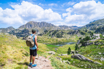 Man stand in an alpine mountain trail
