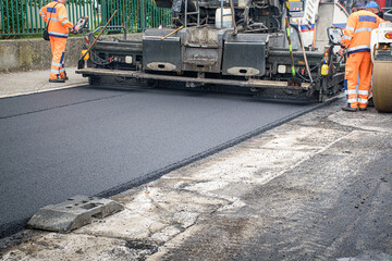 Screed of asphalt paver makes smooth asphalt mat - road reconstruction
