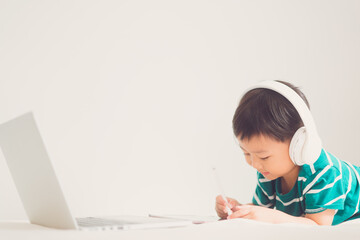 Naklejka premium E-learning, online education at home.Online education.Distance learning, Asian kid child school boy online learning with laptop.Smart kid listen teacher talk.Success, programing, homeschool Student.