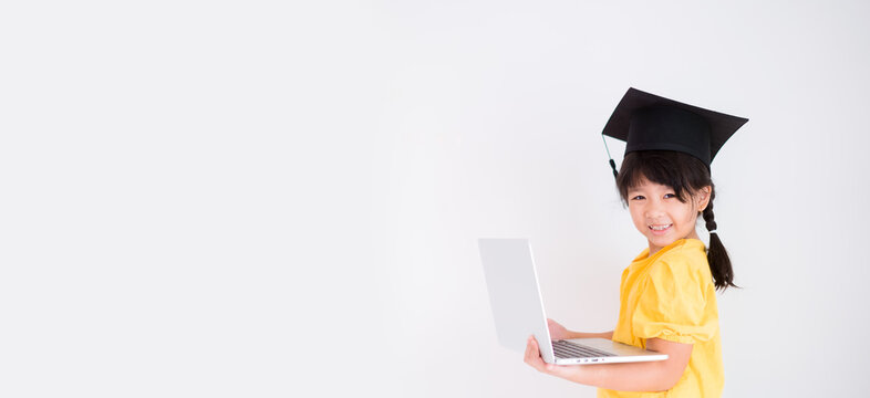 E-learning, online education at home.Online education.Distance learning, Asian kid child school girl online learning with laptop.Smart kid wearing graduate cap.Success, programing, homeschool Student.