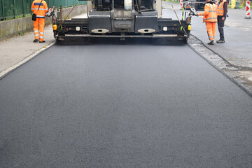 Screed of asphalt paver makes smooth asphalt mat - road reconstruction