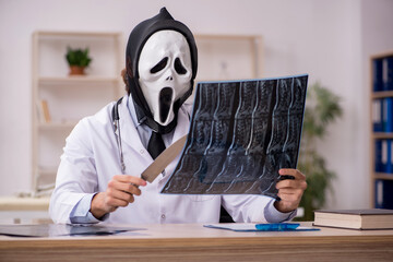 Devil doctor radiologist working in the clinic