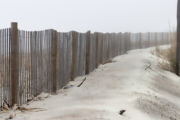  misty wooden fence in sand Hunting Island South Carolina