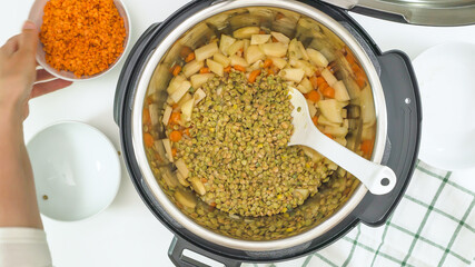 Red lentils, green lentils, and some ingredients close up in a pot. Multi cooker lentil soup recipe
