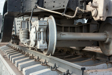 Carriage bogie, perspective view. The main element of the carriage running gear, close-up. A wagon bogie on a railway track. Fragment of the railroad track.