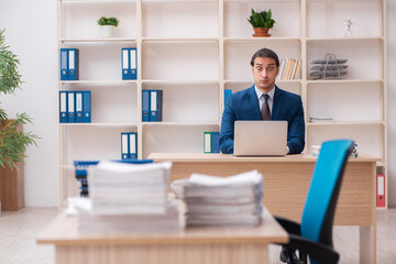 Young male employee unhappy with excessive work