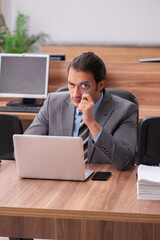 Young male employee working in the office