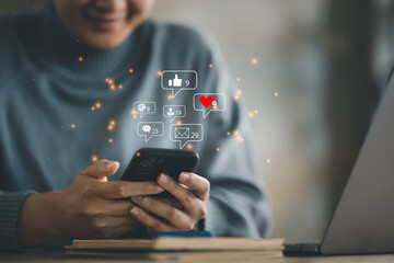 hands of woman using smart phone with notification icons of love, like, message, comment, email, address, shopping and star above smartphone screen, Social, media, Marketing concept.