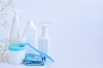 Cleaning products and sponges on a white background. Bottles of detergent and water. copy space