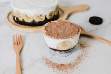 Banoffee cake with bananas, whipped cream, chocolate, caramel, coffee and toffee in cafe restaurant