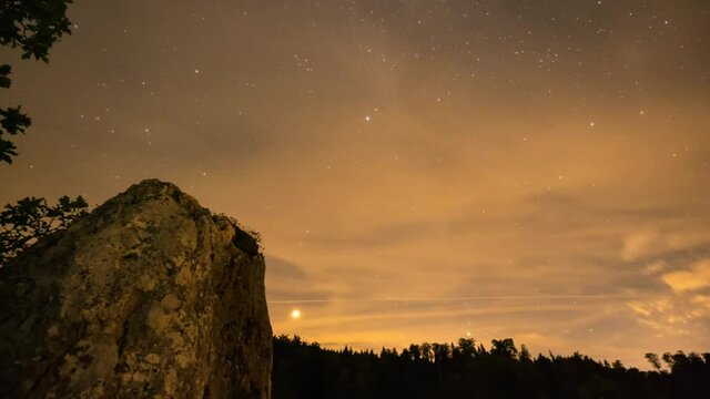 Time lapse shot of the rapidly moving clouds and the starry sky on the top of a mountain in Beuron, Germany