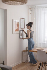 Modern female hanging wall pictures photos in wooden frame decorated scandi minimalistic style room