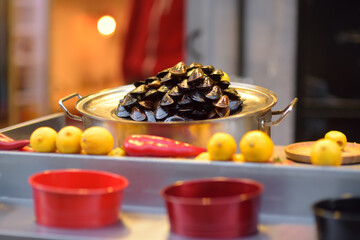 Cooking traditional street food midye dolma. It is stuffed mussels served with a lemon juice. Traditional appetizer seafood in Istanbul, Turkey. Local Turkish cuisine.