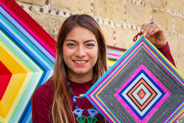A Hispanic female selling knitted mandalas outdoor