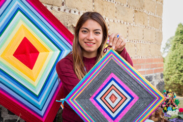 A Hispanic female selling knitted mandalas outdoor