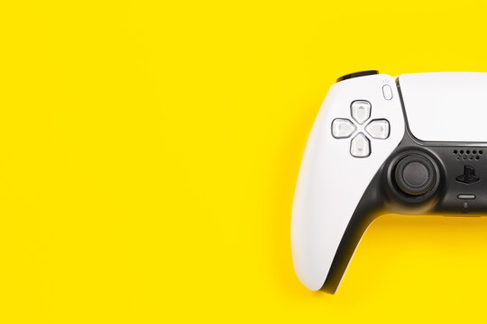 Budva, Montenegro - March 16, 2021: New product from Sony, wireless white Play Station 5 gamepad on yellow background.