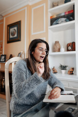 Young deaf woman having a non verbal conversation in online video call