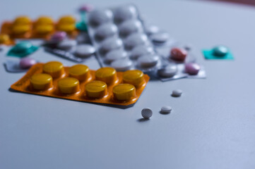 Set of medical pills scattered on a table