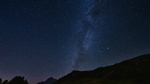 Time lapse of galaxy's stars over Piz Vizan in Switzerland, rotating shot