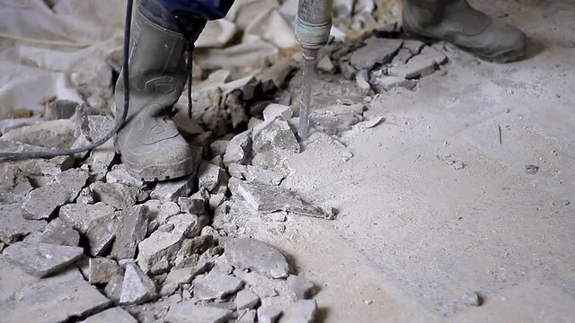 man at work with drill drilling concrete rubble stock footage