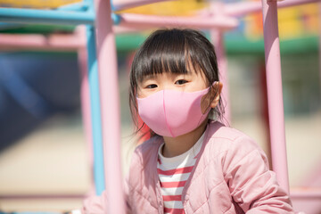 マスクをして公園で遊ぶ女の子