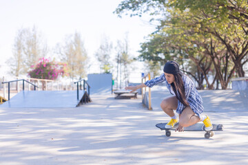 Young asian women play surf skate board at park skate ramp outdoors on morning. Happy women play surfskate board at park . Sport activity lifestyle concept © SSTC STUDIO
