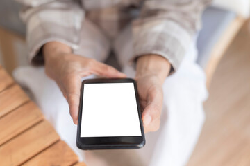Close up women hands holding smartphone, mobile phone, cell phone with white blank screen for copy space. smart phone with blank screen on women hand soft focus selective phone. Technology lifestyle 