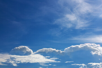 Fototapeta premium Bright blue sky with beautiful clouds. The sky on a sunny day, with clouds and rain forming far away.