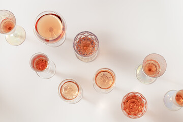 Various glasses of rose wine or champagne sweet and dry, top view. Light alcohol sparkling drink for party.