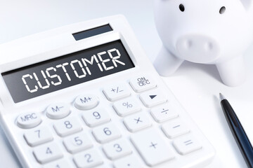 Word CUSTOMER on calculator. Business concept on white background. Top view.