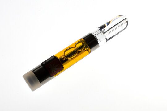 Backlit marijuana vape pen cartridge, with amber-colored resin extract. 