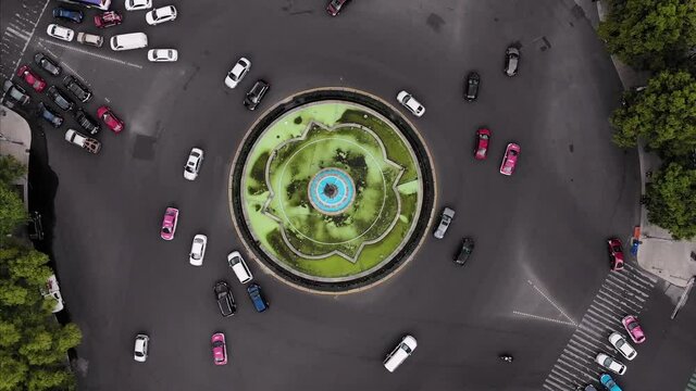 aerial view of a large road with a fountain in the center