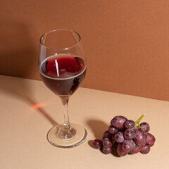 Glass of red wine on the background, with grapes