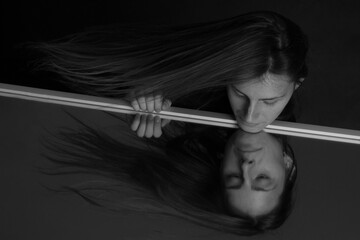 Obraz premium Black and white portrait of a young girl with long hair