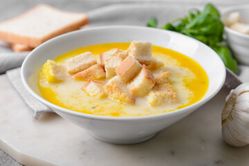 Bowl with tasty garlic cream soup, closeup