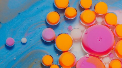 Bright neon colorful bubbles oil and ink, beautiful fluorescent paint. Sparkling color multicolor moving close-up. Acrylic painting. Themes or wallpaper background. Abstract transformation gravitation