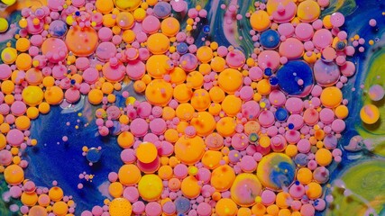 Macro structure of multicolored water paint oil bubbles. Bright colorful acrylic painting. Fantastic surface with chaotic motion liquid. Top view. Mobile phone screen style, theme wallpaper background