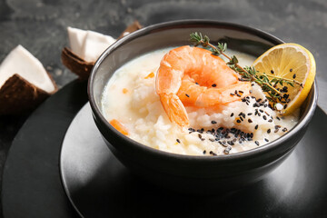 Bowl with Thai rice soup on dark background