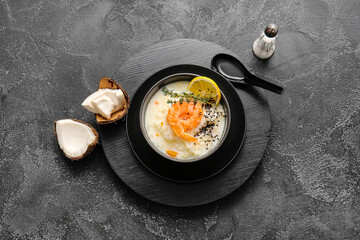 Bowl with Thai rice soup on dark background