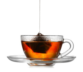 Dipping tea bag in hot water on white background