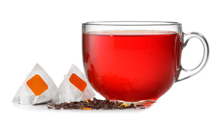 Cup of hot beverage and tea bags on white background